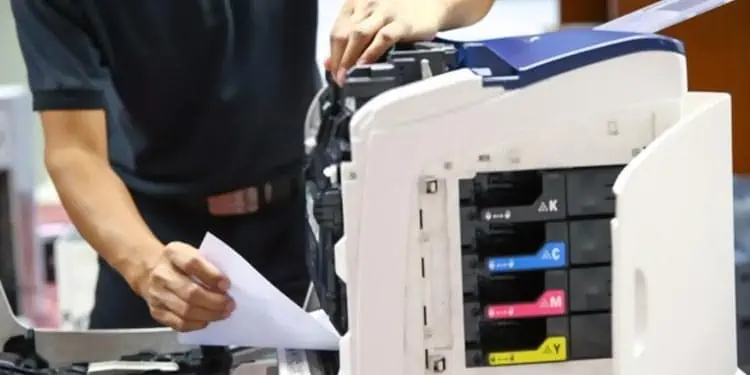 New Ink Cartridge Not Working? 5 Ways to Fix it 11 pulling-papers-out-of-printer