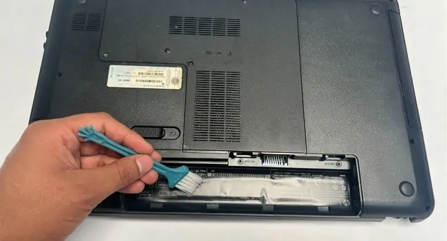 brush-cleaning-external-battery-compartment