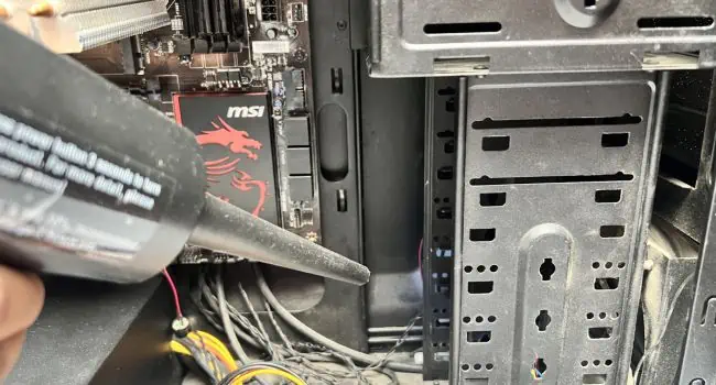 How to Install a Hard Drive? (Step-By-Step Guide) 16 cleaning-pc-dust-using-duster