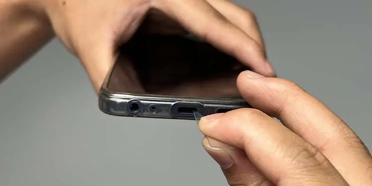 How to Get Sand Out of Charging Port 7 scraping-out-lint-from-charging-port