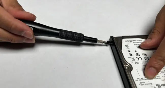 How to Install a Hard Drive? (Step-By-Step Guide) 13 unscrew-hdd-bracket