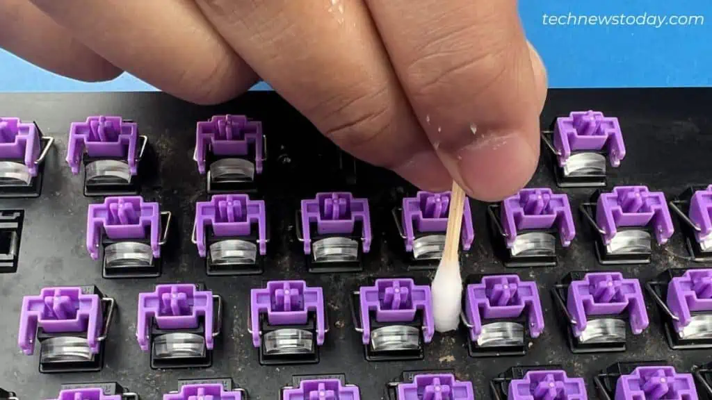 How to Clean Mechanical Keyboard in 7 Steps 10 cleaning-between-keys-using-cotton-swab-1024x576